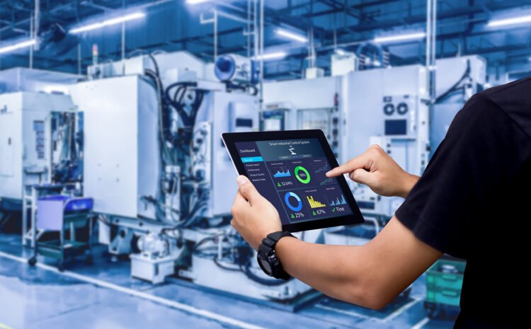 Smart industry control concept.Hands holding tablet on blurred automation machine as background